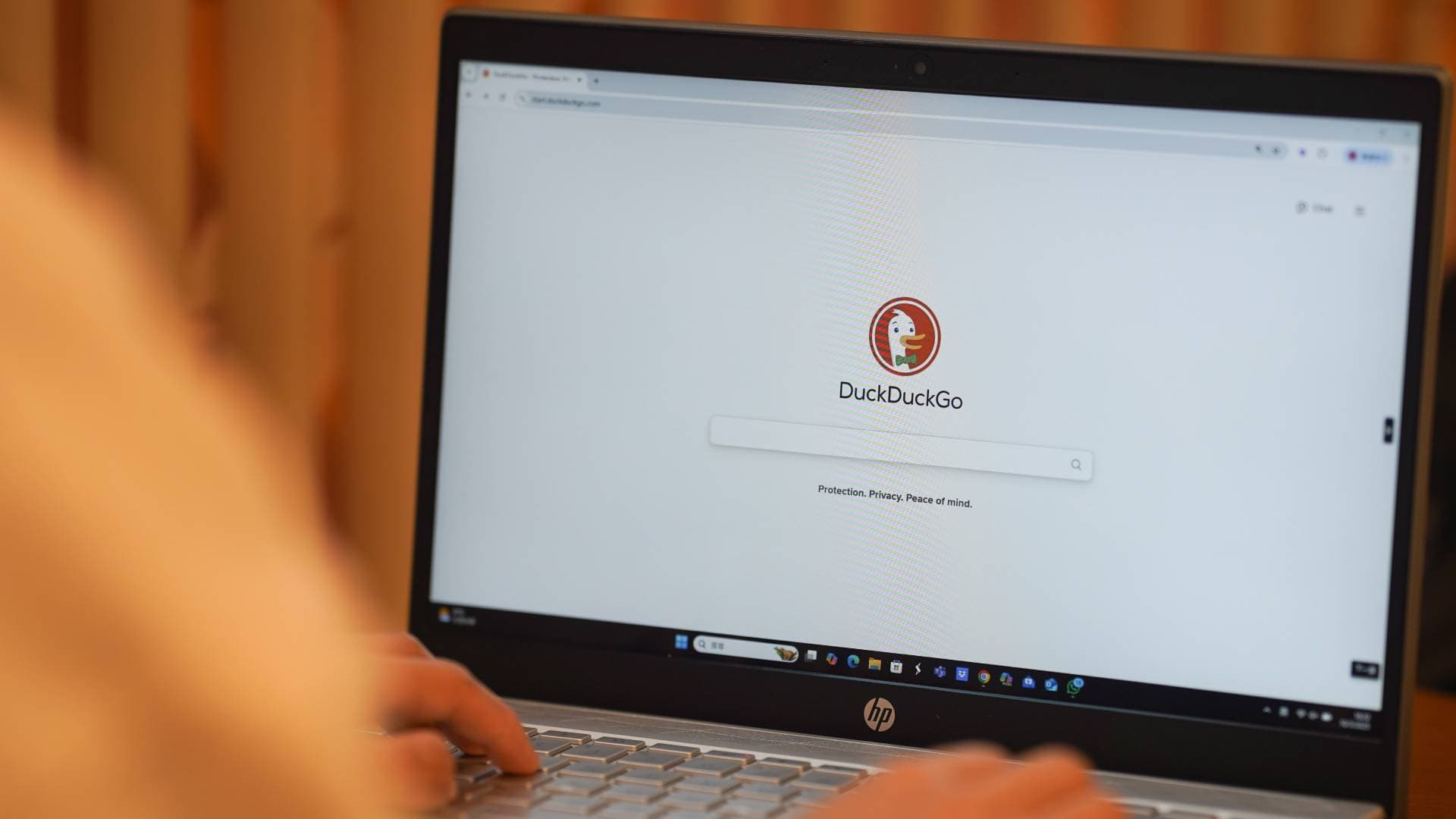 CHINA - 2025/03/19: In this photo illustration, A woman browses DuckDuckGo website on her laptop.