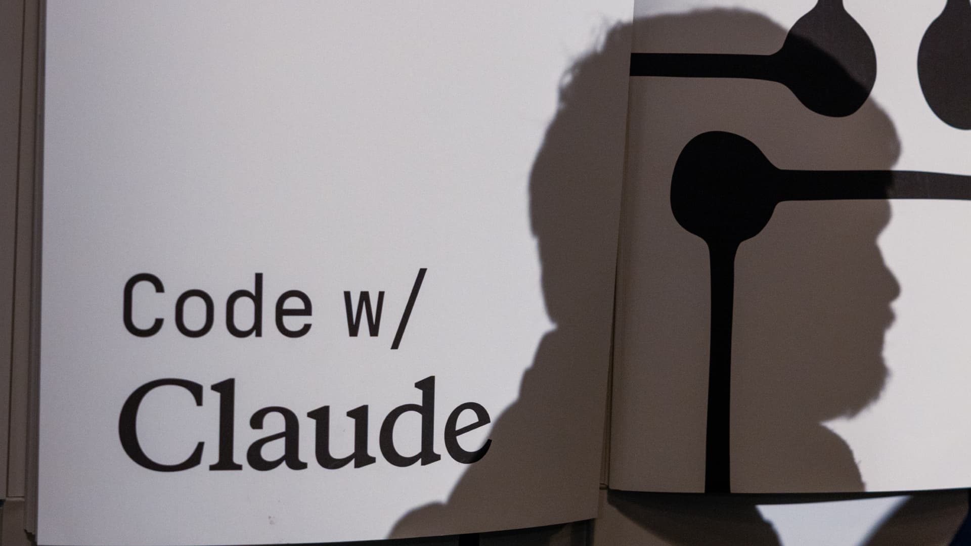 Code with Claude with a man's head as the silhouette.