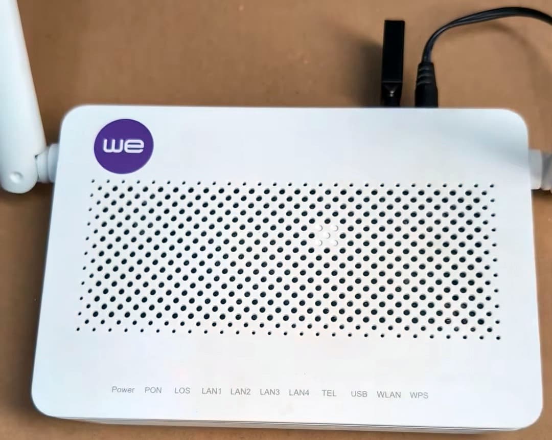A photo of a tiny ad-blocking device plugged into a home fiber gateway device.