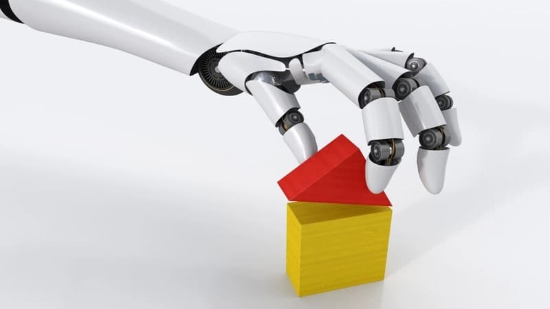 Robot hand building house with building blocks