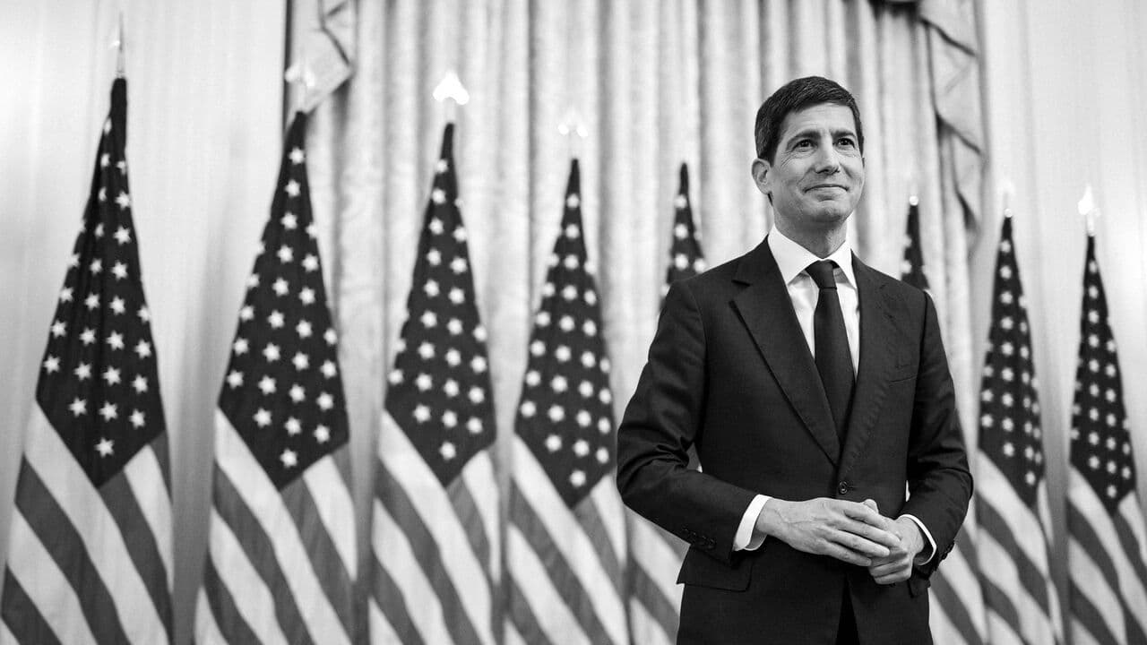 A black and white photograph of the newly appointed U.S. Federal Reserve Chair Kevin Warsh waits onstage for his swearing-in ceremony at the East Room of the White House, Washington DC, USA.