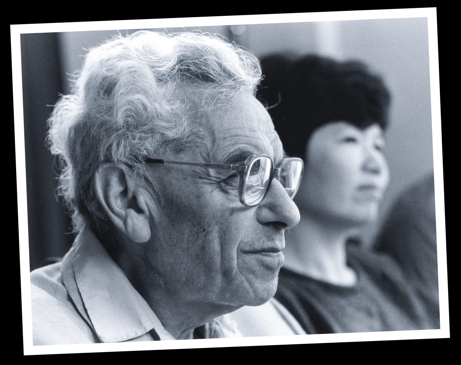Black-and-white photo of a man in glasses.